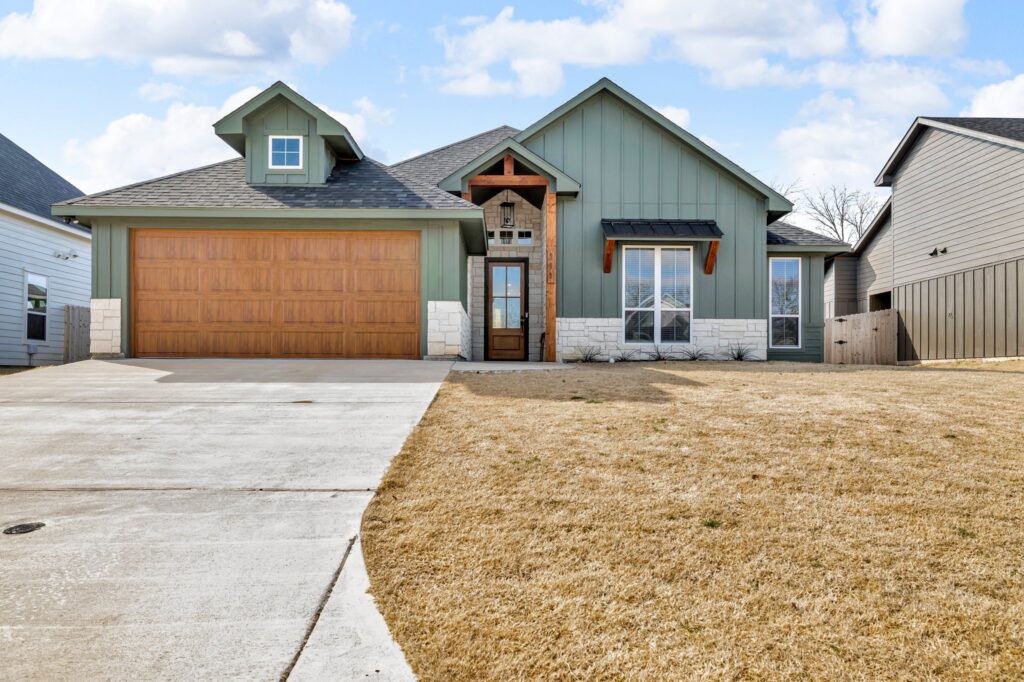 Stunning new home construction at 111 Vaughn Meadows Drive, Tom Bean, TX, featuring a modern exterior and spacious front yard.