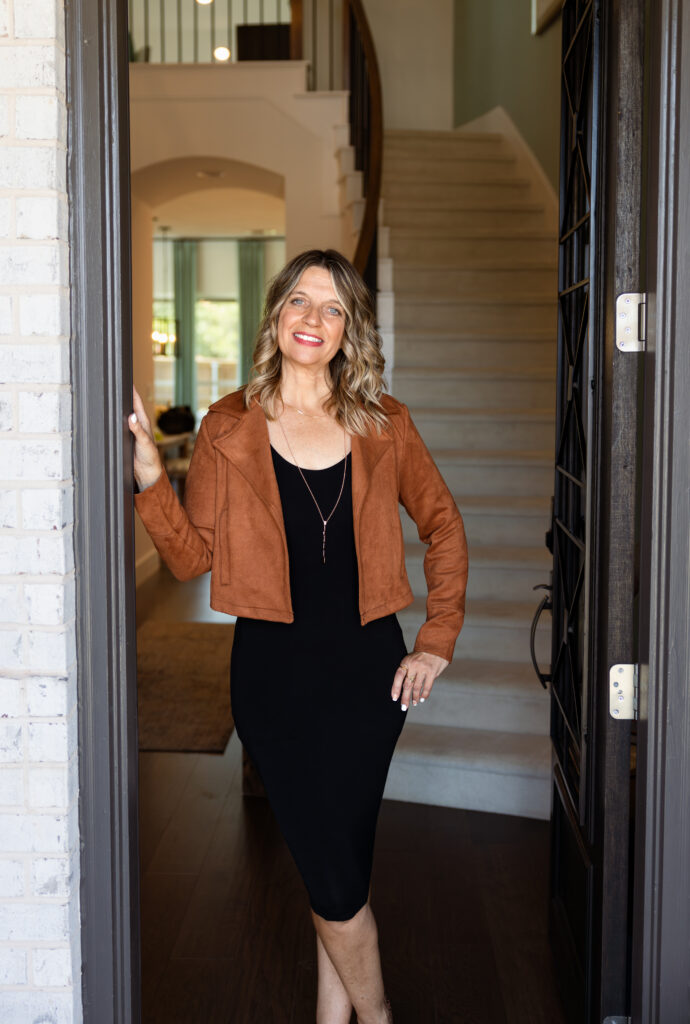 Jonelle Pate reviewing new construction blueprints, showcasing her expertise as a certified new home construction specialist