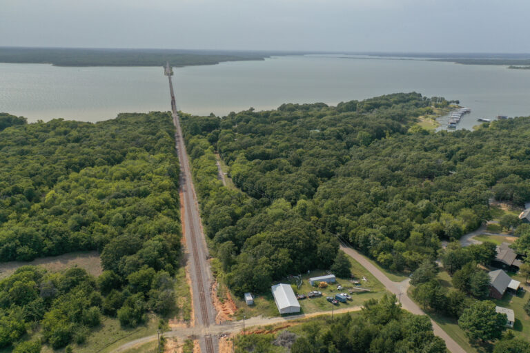 Aerial view of a 1.3-acre lot surrounded by trees near Lake Texoma in Mead, Oklahoma, perfect for building a lake house.